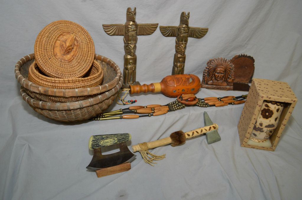 Selection of First Nations collectibles including baskets, rattle, hide ...