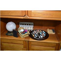 Selection of collectibles including pink quartz globe, gemstone eggs, marble solitaire game etc.