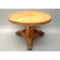 An early Victorian burr maple breakfast table, the circular reel-edged top, raised on triangular...