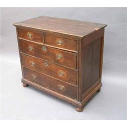 # An early 18th century elm and oak chest, having moulded top over two short and three graduated...
