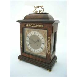 A walnut bracket clock, having twin fusee movement and brass dial with silvered Roman chapter rin...