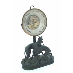 A Victorian aneroid barometer with exposed mechanism, in circular glazed case, mounted on an elec...