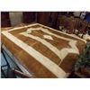 Image 1 : LARGE COW HIDE PATCHWORK RUG - 96 X 64" - SEEN FITTING ON A QUEEN BED IN PICTURE - STITCHED WITH