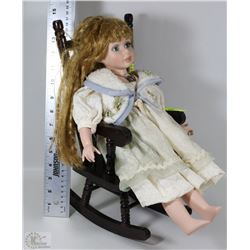 DECORATIVE PORCELAIN DOLL IN ROCKING CHAIR