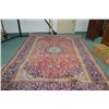 Image 1 : Iranian wool area rug with large center medallion, multiple borders, in tones of reds, blue, green a