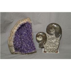 An fossilized ammonite 6 1/2" in height and a geode section, approximately 8" in diameter