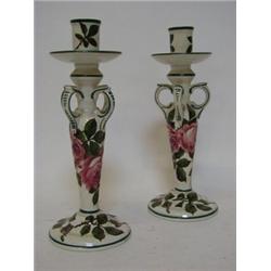 A PAIR OF WEMYSS WARE CANDLESTICKS, briar rose pattern, four thumb rings to the tapered stems, ci...