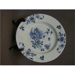 A TIN GLAZED EARTHENWARE PLATE, c.1765, underglaze blue enclosed pool and foliage, dog rose borde...