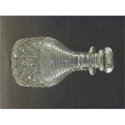 A REGENCY STYLE CLEAR CUT GLASS DECANTER, Prussian Shape, stopper, ring neck, diamond cut base, g...