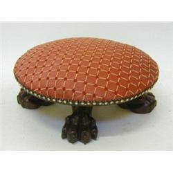 A MAHOGANY FOOTSTOOL, circular, recent diaper crimson upholstery, lion's paw feet, height 15cm, d...