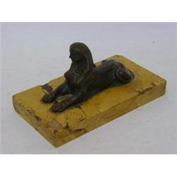 A PAPERWEIGHT, bronze, Sphinx on giallo antico slab, length 17cm  80-120...