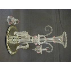 A VICTORIAN TABLE EPERGNE, circular mirror glass plinth, holding a clear glass central trumpet, s...