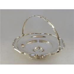 A SILVER PLATED SWING HANDLE BASKET, circular with shaped reeded border and handle, diameter 25cm...