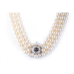 A Three Strand Cultured Pearl and Diamond Necklace