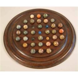 A group of 32 gutta percha marbles, with marbled decoration, 4 glass marbles and a solitaire boar...