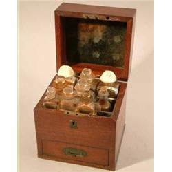 A late Georgian mahogany domestic medicine chest, with baize fittings, containing nine glass bott...