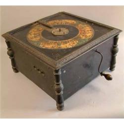 An Ariston table top polyphon, with ebonised case printed with a gilt band of cherubs, 18in. toge...