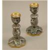 Image 1 : A pair of Naples porcelain candlesticks, moulded with classical figures 6.5in....