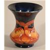 A Moorcroft Poppy pattern trumpet vase, with dark blue ground. 4.5in....