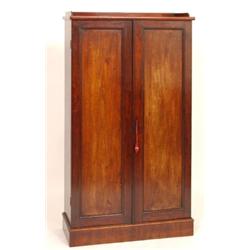 A 19th Century Mahogany Cupboard, the galleried top above a pair of cupboard doors on a plinth ba...