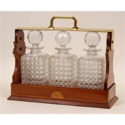 An Edwardian Inlaid Mahogany Tantalus, and cut glass decanters (one a.f.) 41 cm  See illustration...