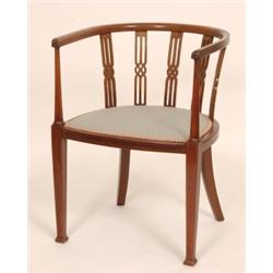 An Edwardian Mahogany Tub Chair, with pierced back splats and chequer inlay, on square tapering l...