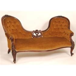 A Victorian Walnut Camel Back Sofa, the carved show wood decorated flowers, on cabriole legs, 178...