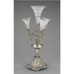 A good late Victorian epergne, the central clear glass trumpet vase and three smaller supporting...