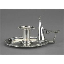 A good George III chamber candlestick, the circular crested tray and cylindrical sconce with spir...