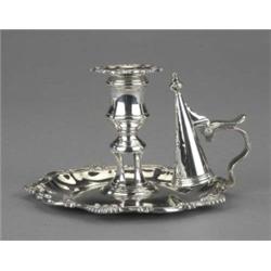 A William IV chamber candlestick, the crested shaped circular fluted tray and detachable nozzle c...