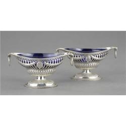 A good pair of Victorian navette shaped pierced pedestal salt cellars, in George III neo-classica...