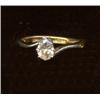 A single-stone diamond ring, c.1980, the claw set pear shaped stone mounted within twisted should...
