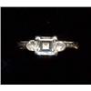 A single-stone diamond ring, c.1985, the central claw set emerald cut stone with single collet se...