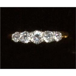 A five-stone diamond ring, c.1950, graduated claw cut stones    £280/350...