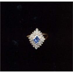 A 9ct gold sapphire and diamond cluster ring, of lozenge design, the central sapphire with a two-...