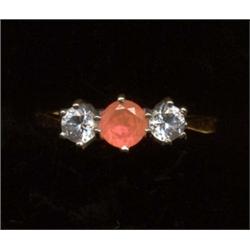 A 14ct gold three-stone pink sapphire and diamond ring, the central sapphire with slightly smalle...