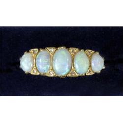 An 18ct gold five-stone opal ring, in 19th century style, the five graduated oval opals intersper...