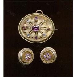 A foiled garnet and chrysolite suite of brooch and earrings, c.1840, the brooch of foliate design...