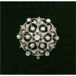 A diamond brooch, c.1880, of circular design interspersed with graduated collet set brilliant cut...