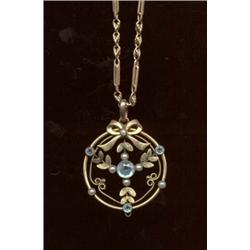 A blue paste and imitation pearl pendant, c.1900, of foliate and ribbon design, suspended from a...