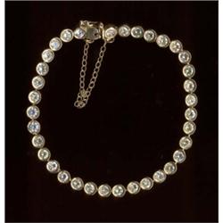 A diamond tennis bracelet, c.1980, each stone mounted in articulated rub-over setting (some stone...