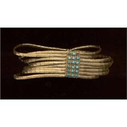 An eight-row bracelet, in 19th century style, c.1965, the triangular articulated links with satin...