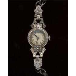 A diamond cocktail watch, c.1920, the silvered dial with Arabic numerals and quartered hours, bez...