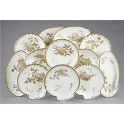 A Wedgwood 'Marine' dessert service, of shell shape, the ivory ground enamelled and gilt with dif...