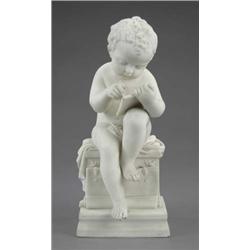 A Parian figure of a naked boy, seated on a chest busily writing, on square base, 11in high     £...