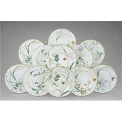 A Minton part dessert service, painted with wild flowers, grasses and butterflies on a soft green...