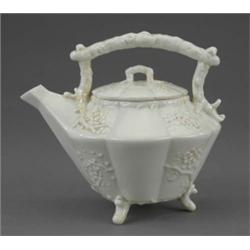 A Belleek teapot and cover, Thorn pattern, of lobed circular form, moulded with blossom, extendin...