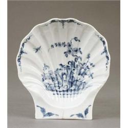 A Worcester fluted scallop shell dish, painted with flowers issuing from rocks in the Chinese sty...