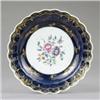 Image 1 : A Worcester deep plate, painted with central flower sprays, the wide royal blue border gilt with...