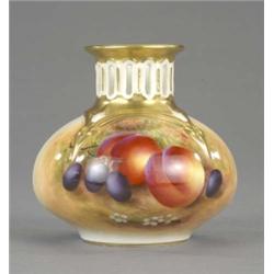 A Royal Worcester compressed circular vase, the narrow neck vertically pierced, painted with peac...
